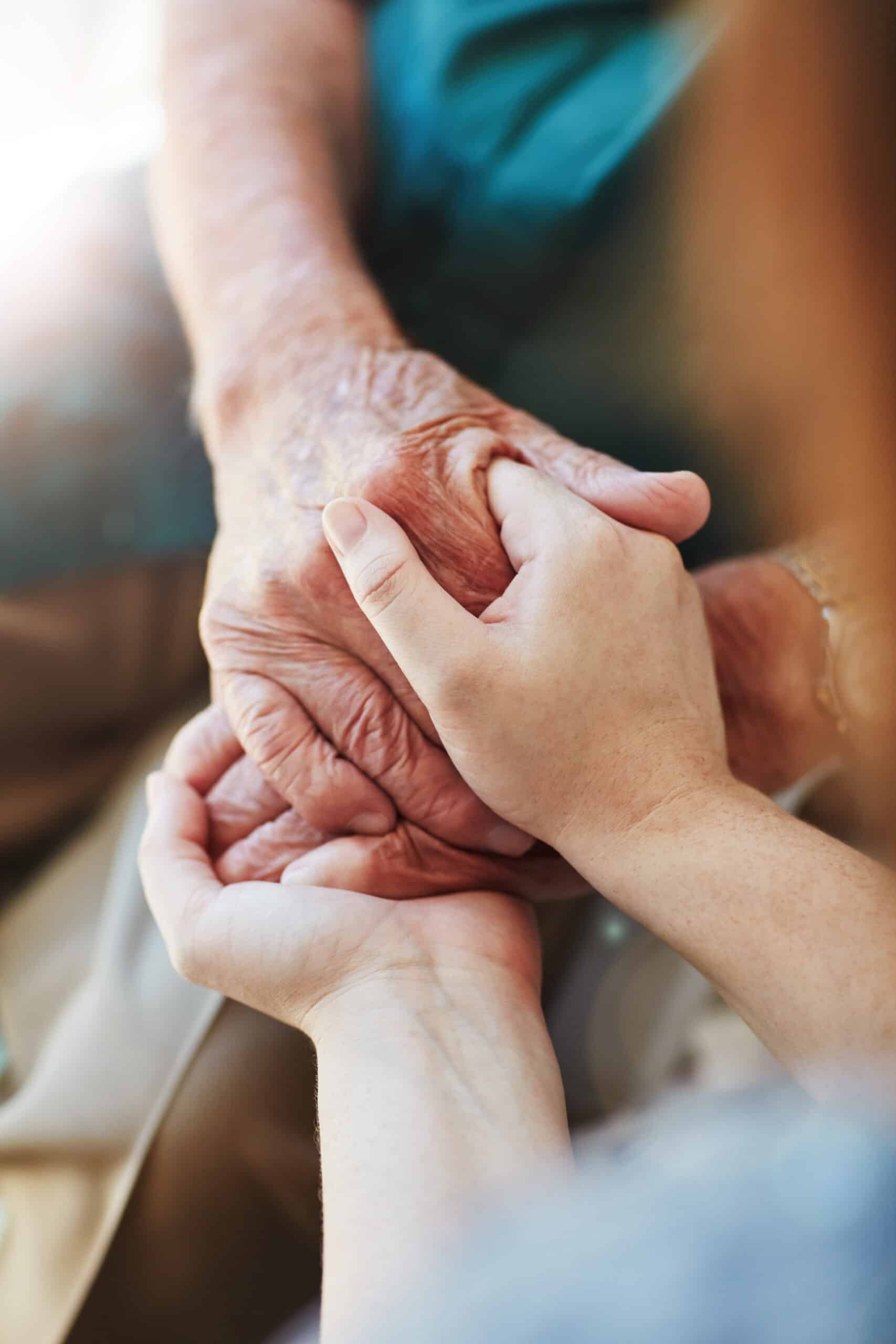 Woman, senior man and holding hands for support with care and empathy while together for closeup. Hand of elderly male and person for hope, trust and kindness or help with life insurance and health.